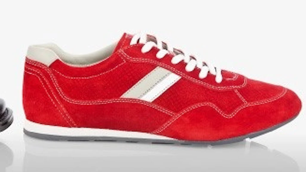 Red trainer lying in front of a black leather shoe
