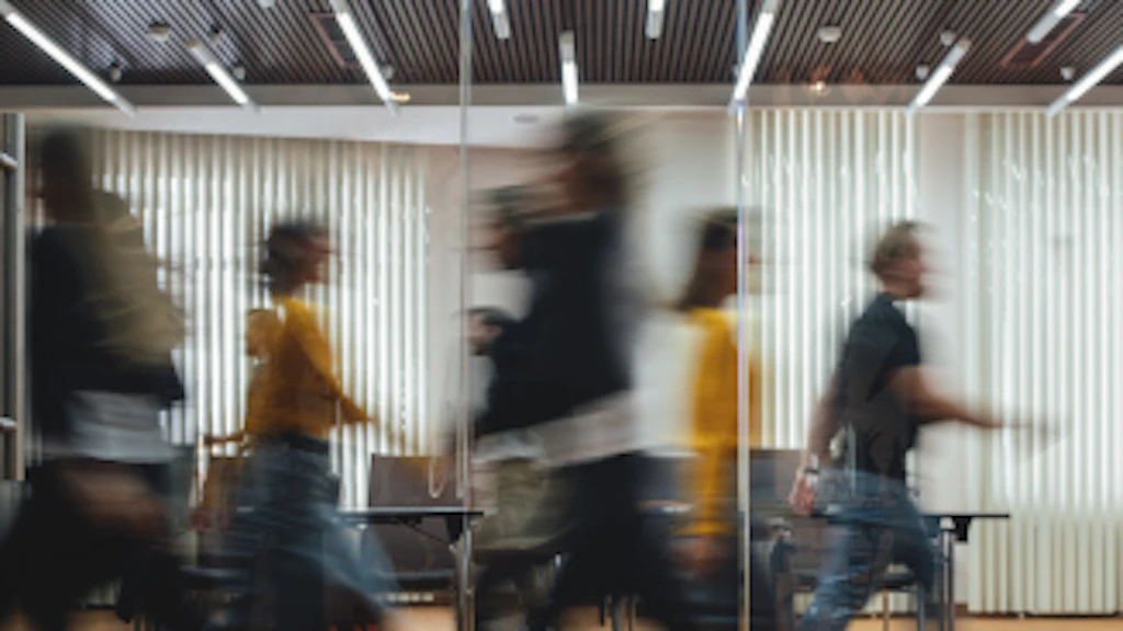 Men and women move into an office