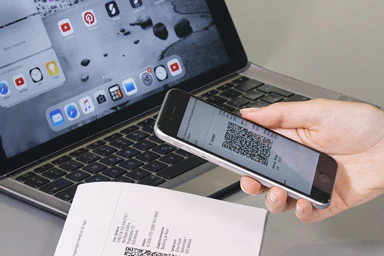 A person consults a QR bill.