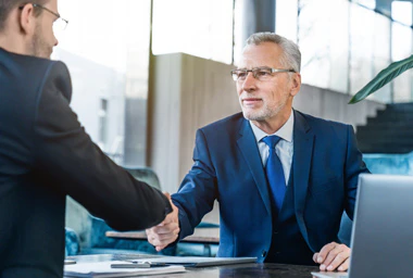 Two businessmen shake hands.