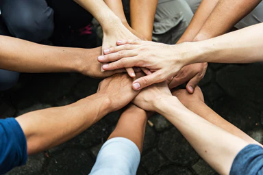 People join hands as a sign of unity.