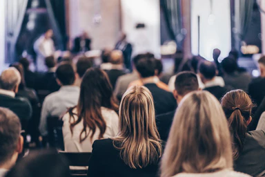 People attending event seen from behind.