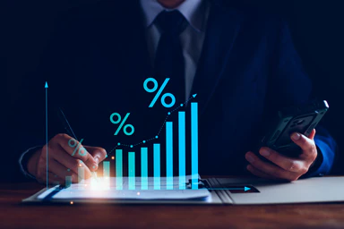 A suited individual stands behind percentage-topped charts.