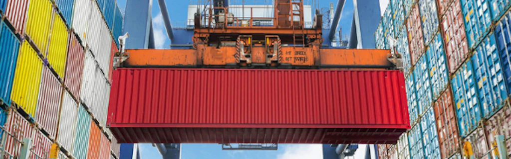 A crane moves containers in a port 