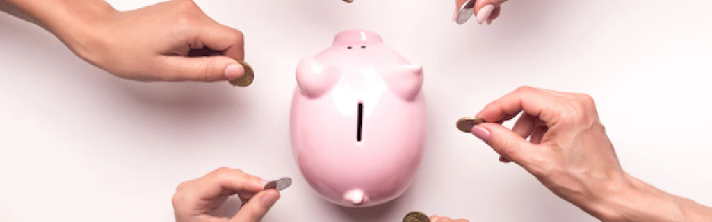 Six hands each deposit a coin in a piggy bank