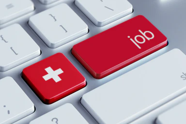 Un clavier d’ordinateur avec une touche marquée d’une croix suisse et une autre du terme «job».