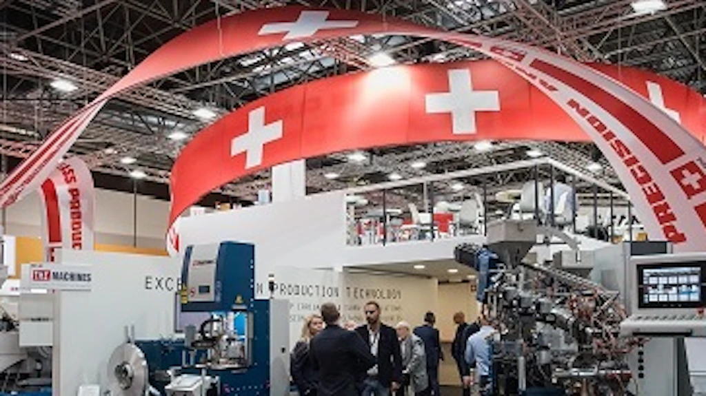 Des personnes aux stands d'exposition avec des drapeaux suisses