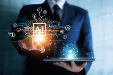 Un persona tocca uno schermo trasparente sul quale appaiono le lettere A.I.